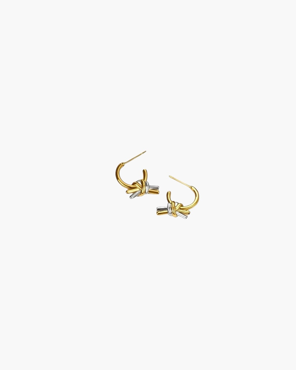 Linked Knot Hoop Earrings in 18K gold plated finish with silver knot detail and polished sculptural design.