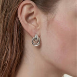 Sculpted interlock drop earrings in 925 silver plated finish featuring smooth polished layered loop design.
