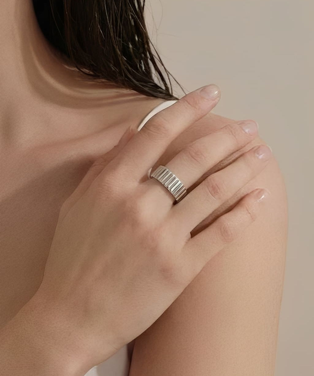 Minimal ridge band ring worn on hand with a clean modern design
