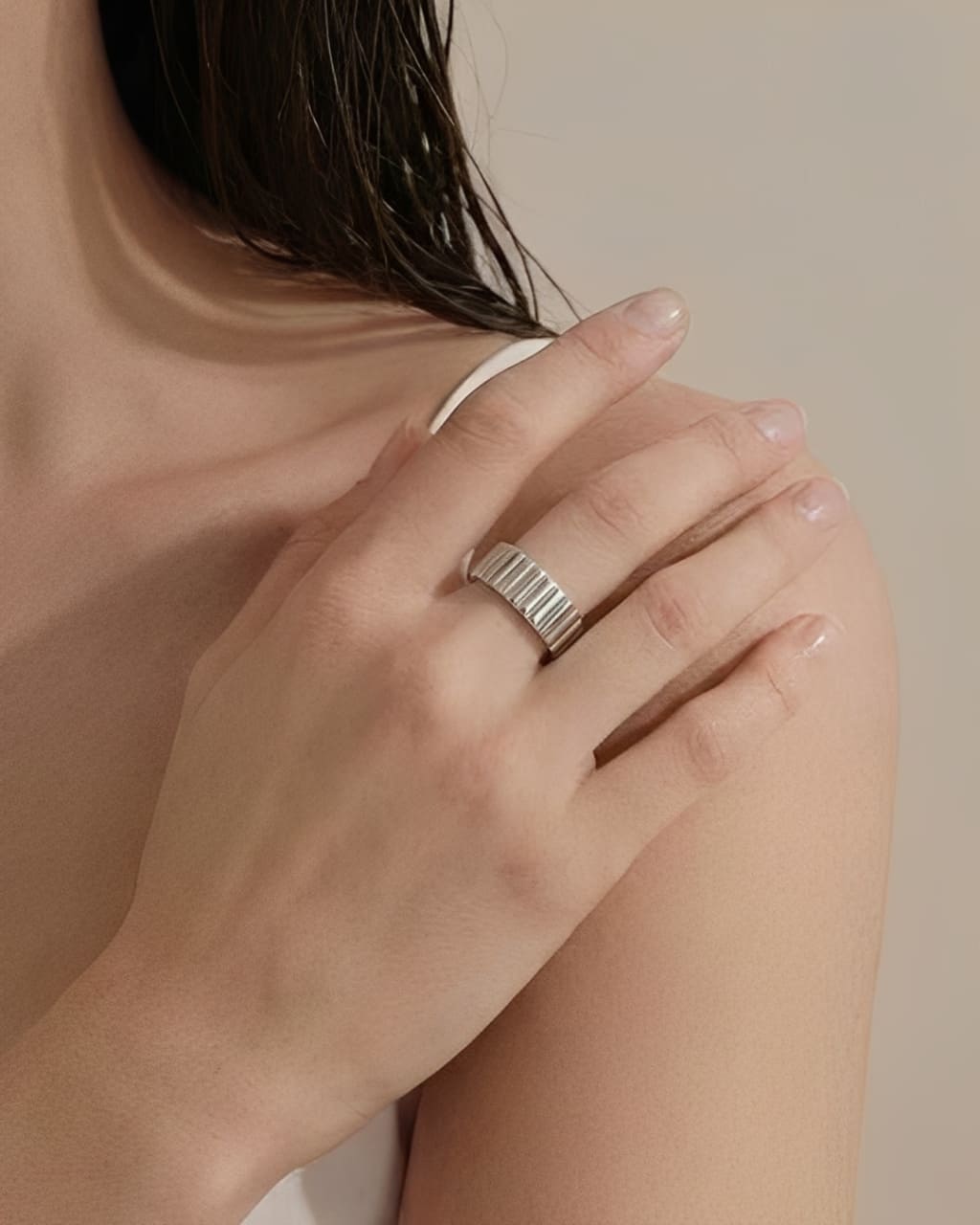 Minimal ridge band ring worn on hand with a clean modern design