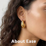 Model wearing About Ease soft drop gold stud earrings with a polished minimalist teardrop design