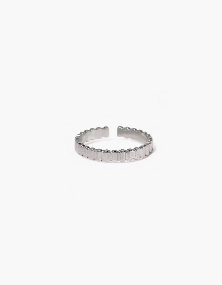 Block Line Ring in stainless steel with evenly spaced block segments and an adjustable open band