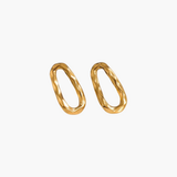 Calm Oval Earrings in 18K gold plated stainless steel with softly textured irregular oval design.
