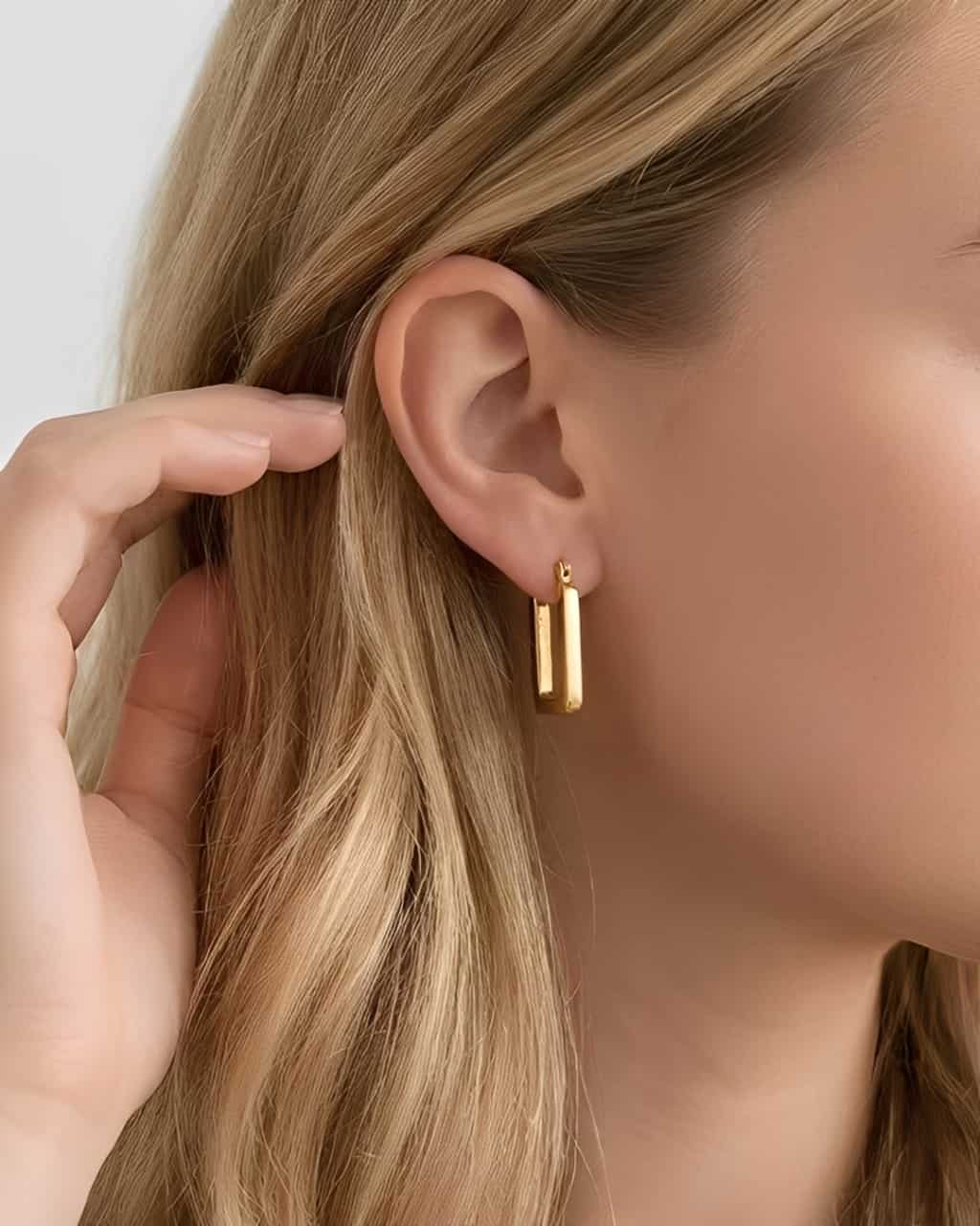 Clean Frame Hoop Earrings worn on ear, minimalist geometric hoop earrings with a rectangular silhouette