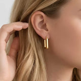 Clean Frame Hoop Earrings worn on ear, minimalist geometric hoop earrings with a rectangular silhouette