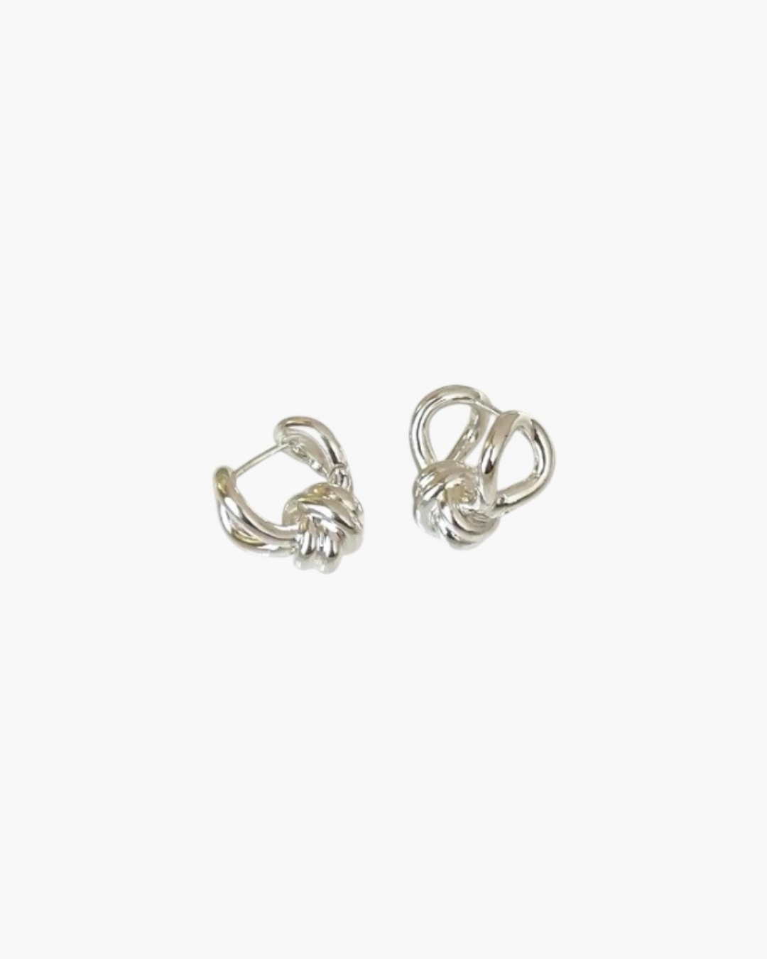 Compact Knot Earrings in stainless steel with sculptural interwoven knot detail.
