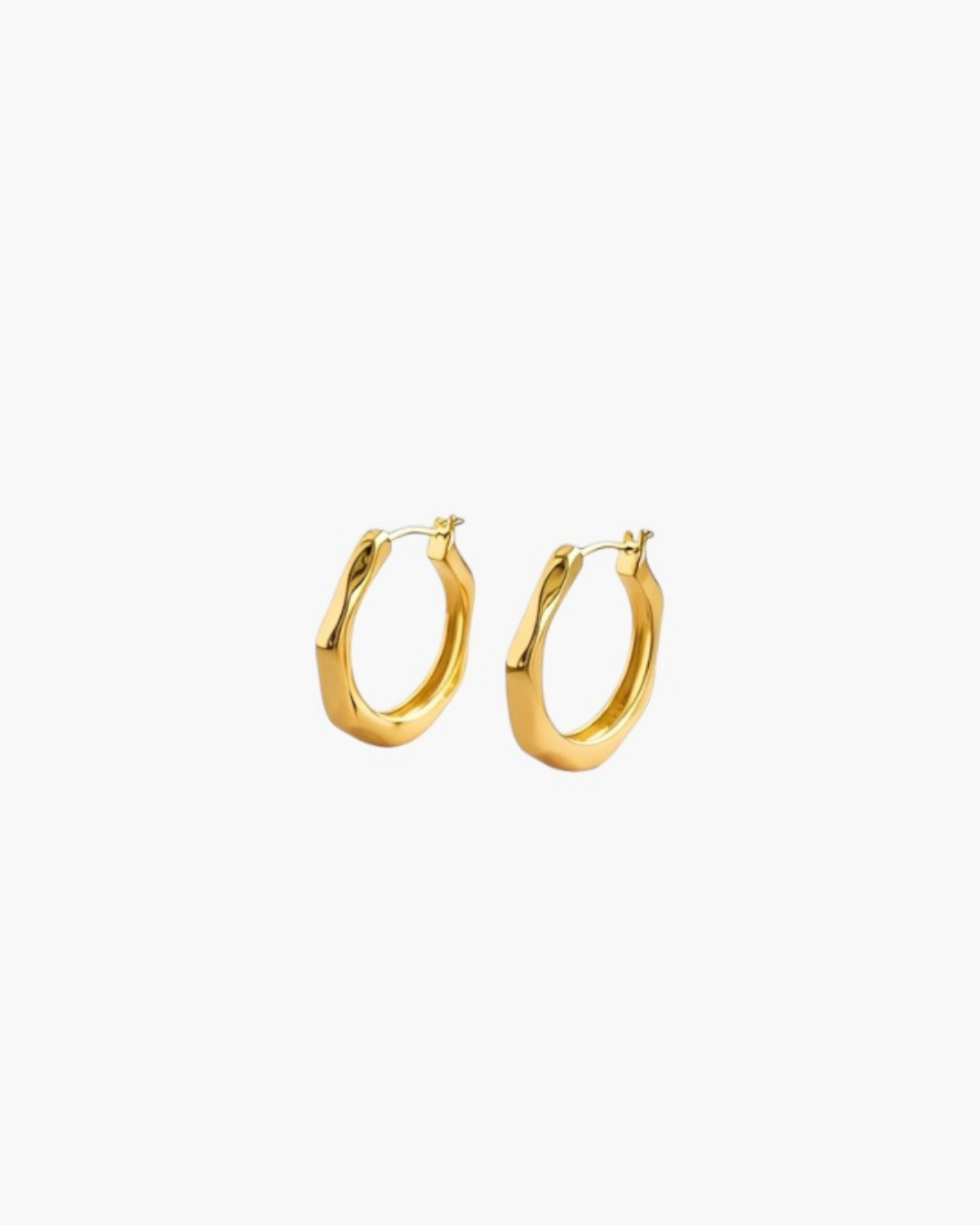 Contour Twist Hoop Earrings in 18K gold plated finish with a polished softly contoured hoop design.
