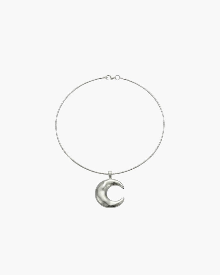 Minimalist crescent moon pendant necklace with smooth sculpted moon charm.