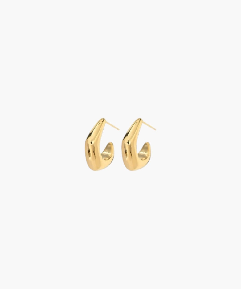 Side view of Ease Hoop Earrings in 18K gold plated finish showcasing the sculpted curved silhouette and high-polish surface.