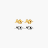 Essential Knot Stud Earrings in gold and silver finishes with polished sculptural knot design.