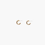 Close-up of gold chunky hoop earrings with polished minimalist design