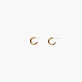 Close-up of gold chunky hoop earrings with polished minimalist design