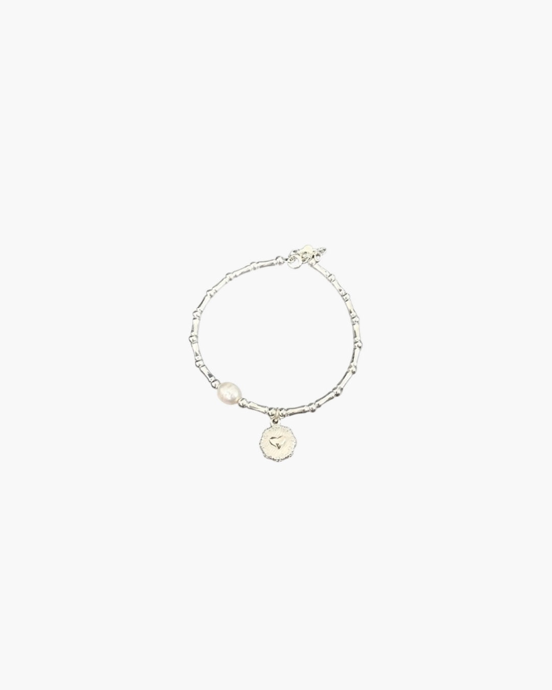Minimal silver bracelet with heart coin charm by About Ease.