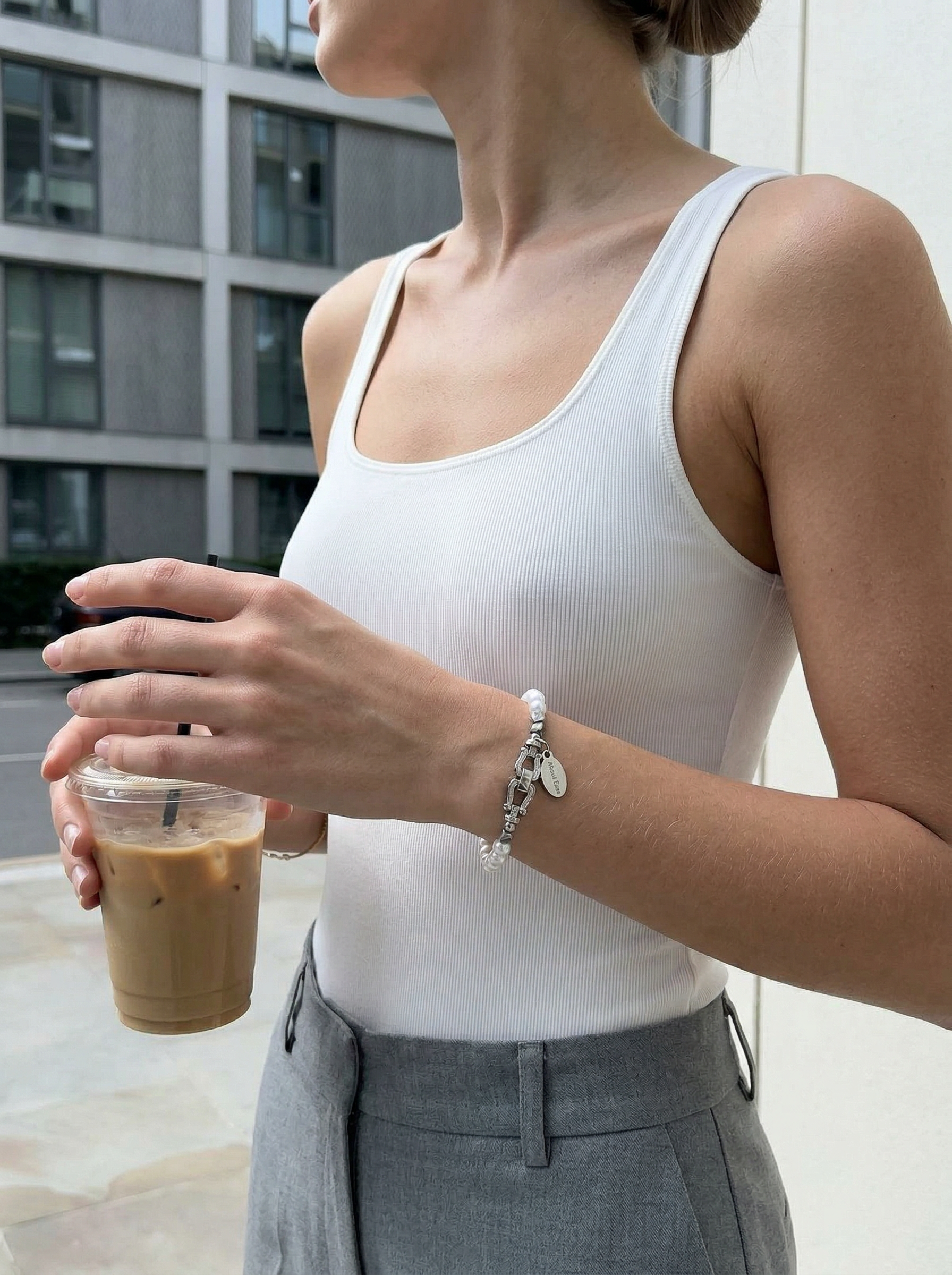 horseshoe pearl bracelet worn with casual outfit minimalist style
