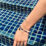 horseshoe pearl bracelet worn on wrist by pool lifestyle shot