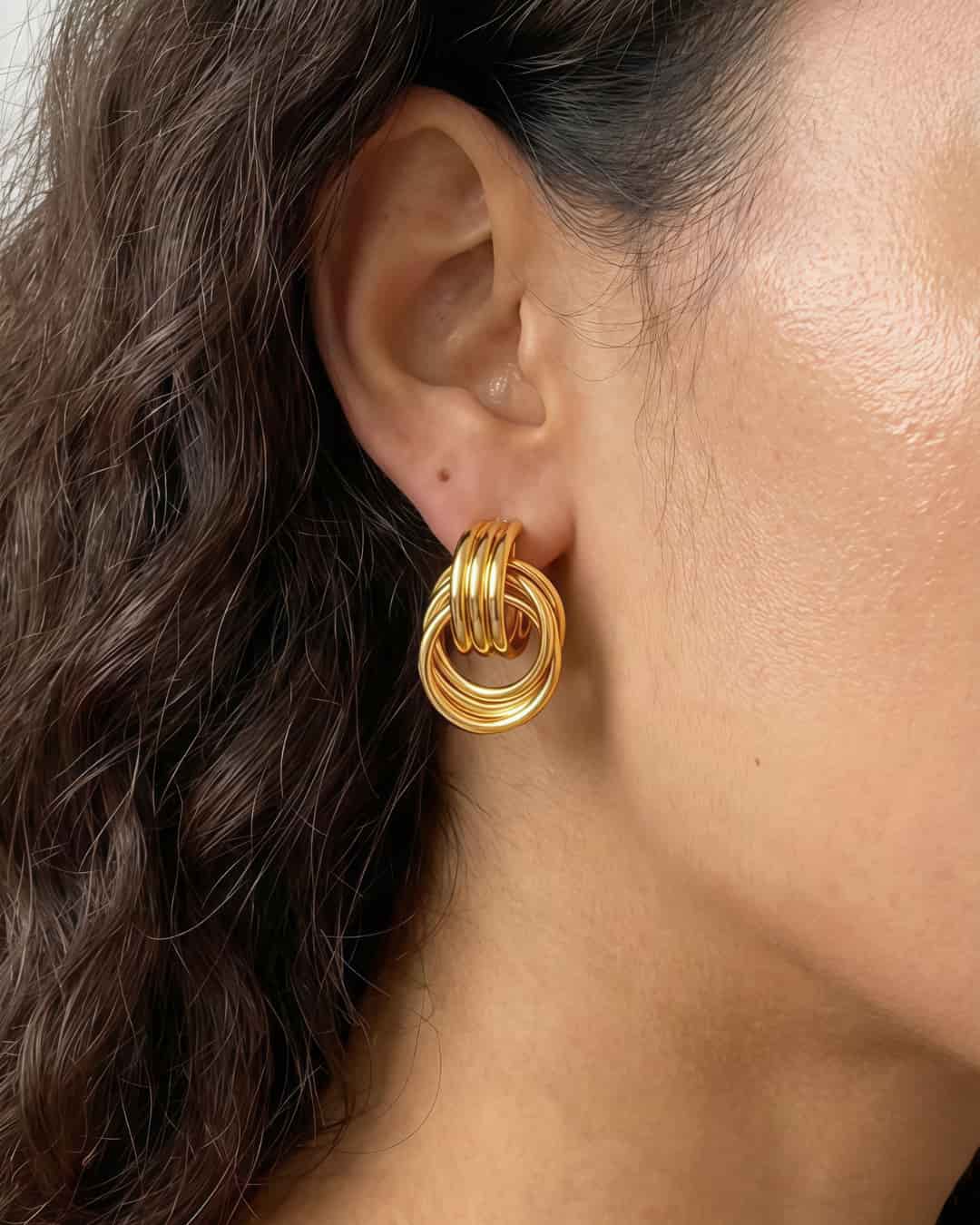 Model wearing interlock loop earrings with a clean minimalist look