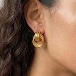 Model wearing interlock loop earrings with a clean minimalist look