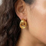 Model wearing interlock loop earrings with a clean minimalist look