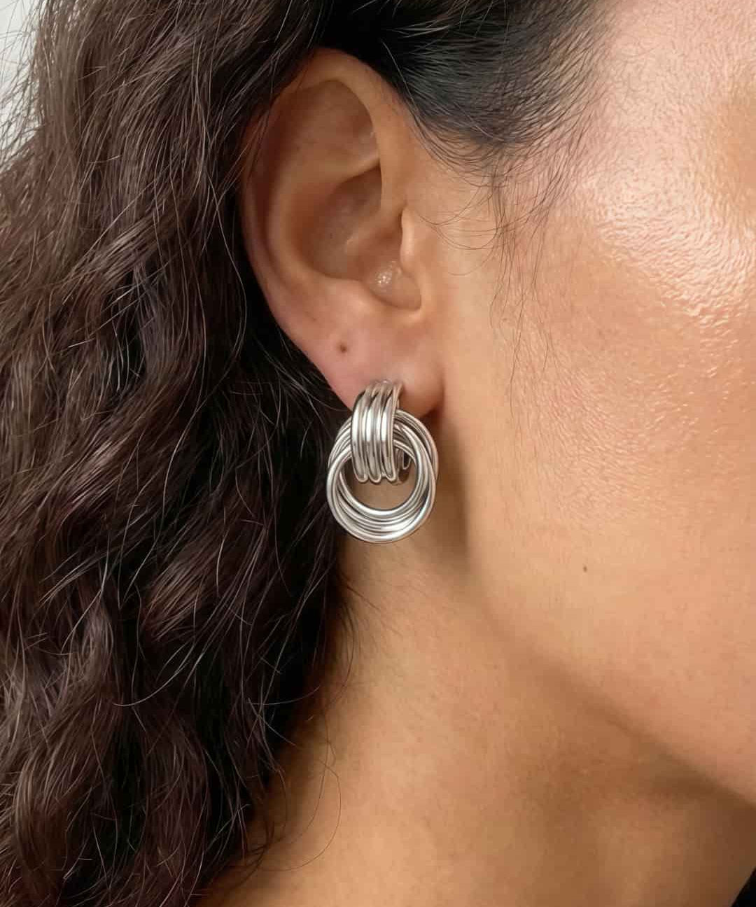 Silver interlocking loop earrings with a modern sculptural finish