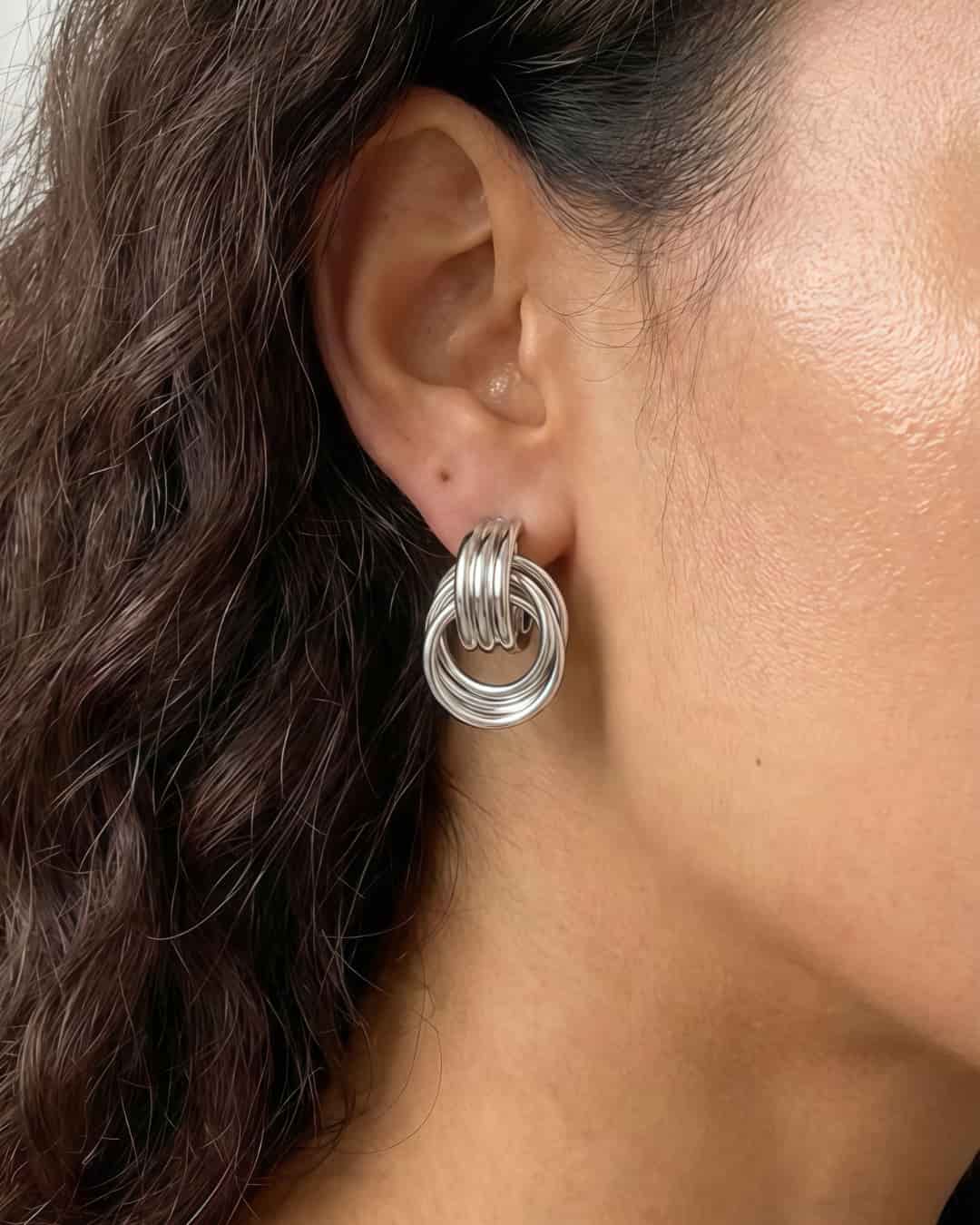 Silver interlocking loop earrings with a modern sculptural finish