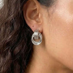 Silver interlocking loop earrings with a modern sculptural finish