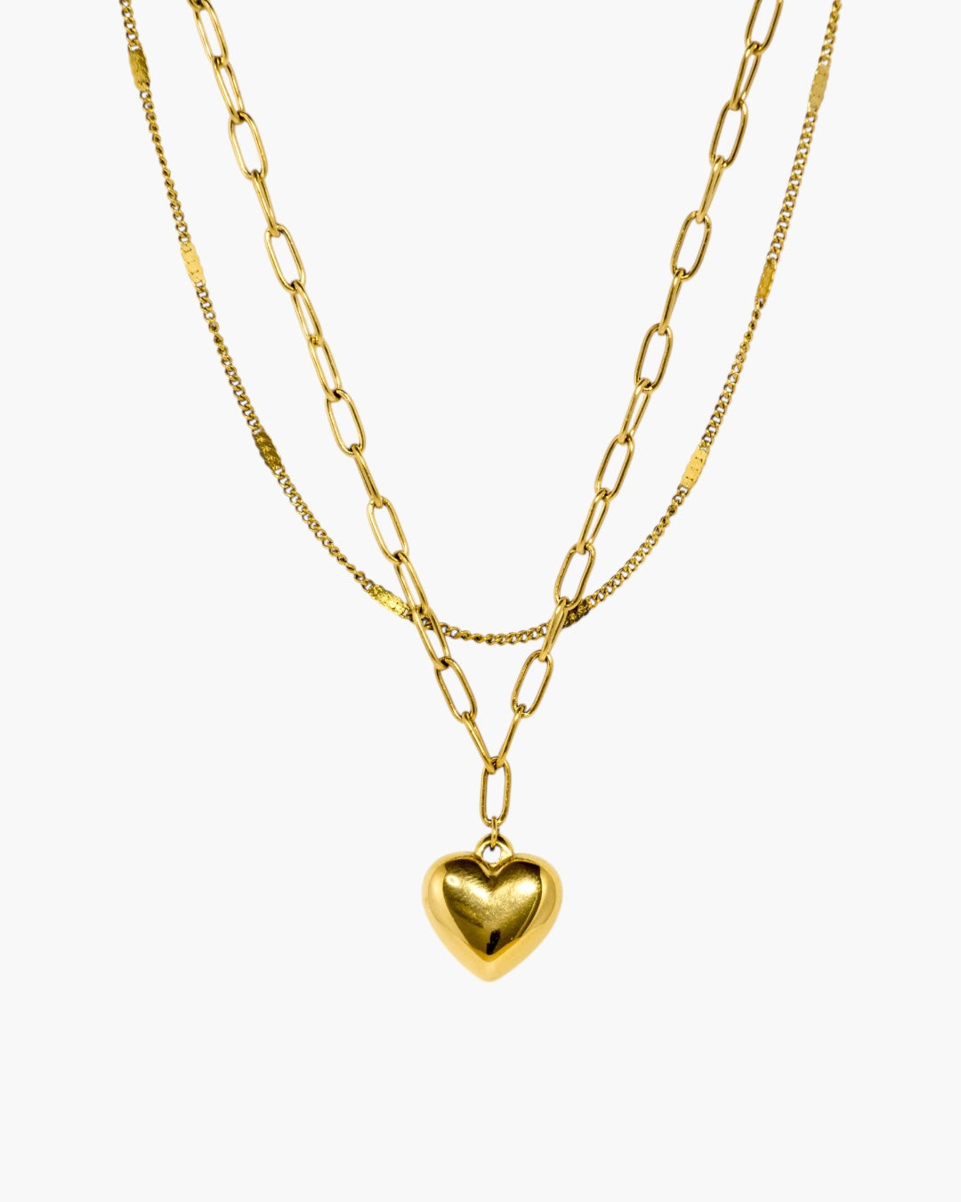 Layered gold chain necklace with polished heart pendant and linked chain detail.
