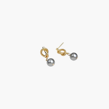 Modern Pearl Drop Earrings in 14k gold plated finish featuring a sculptural knot and gray pearl drop, angled view.