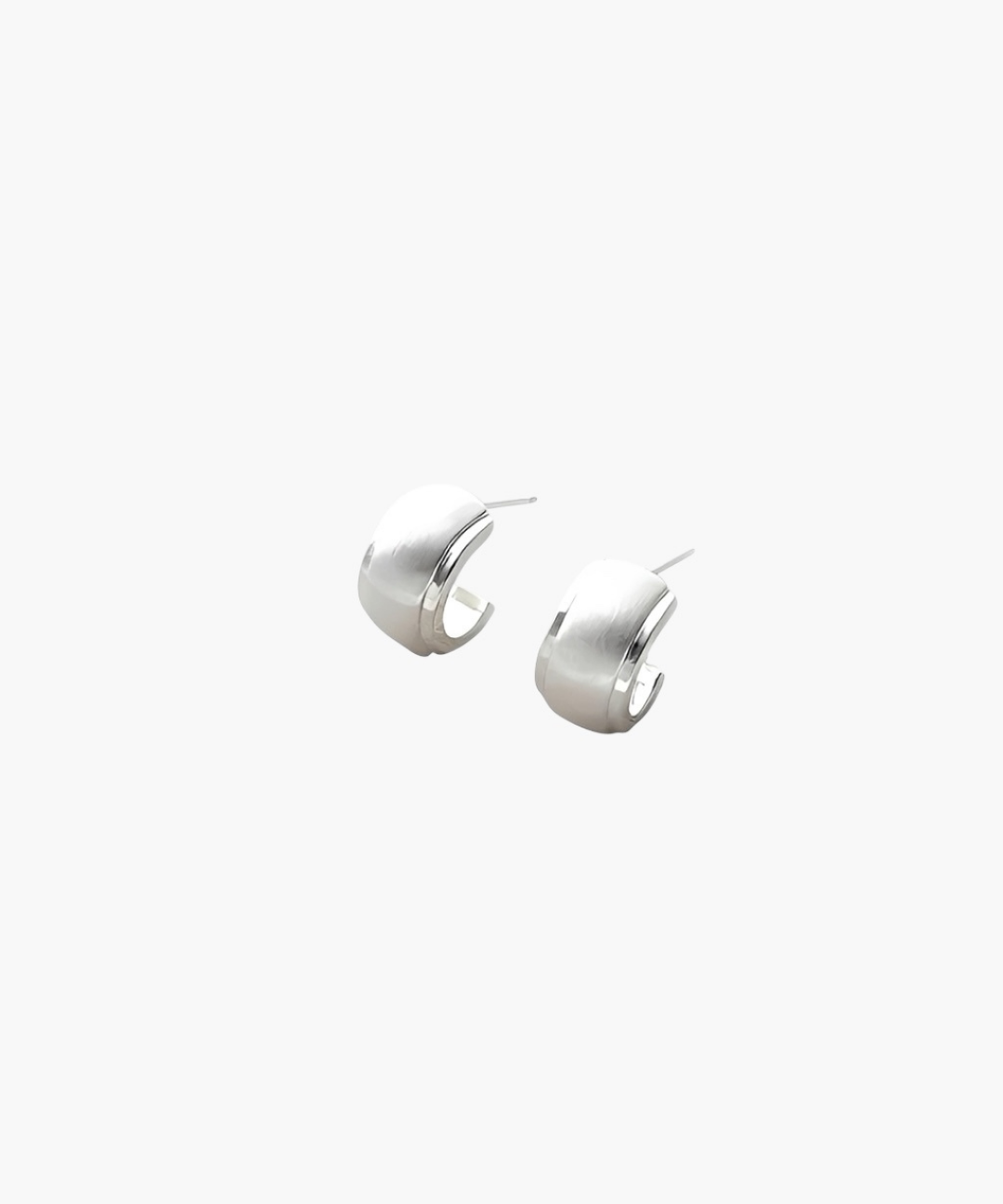 Quiet Curve Huggie Earrings in silver tone with brushed finish and polished edges, minimalist curved design.