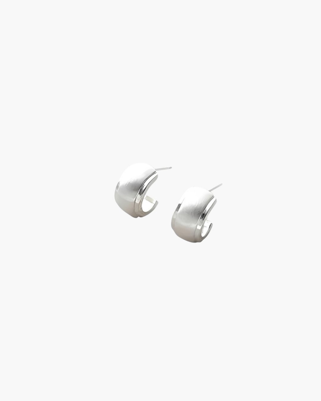 Quiet Curve Huggie Earrings in silver tone with brushed finish and polished edges, minimalist curved design.