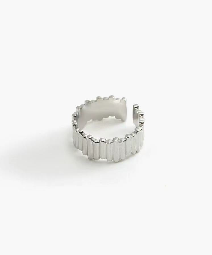 Ridge Band Ring in stainless steel with vertical ridged detailing and an adjustable open band