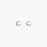 Close-up of silver chunky hoop earrings with polished minimalist design
