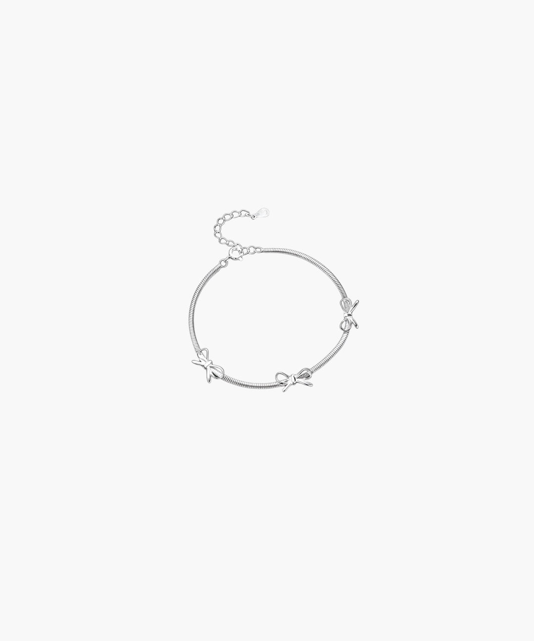 Silver ribbon accent bracelet with delicate bow details and adjustable chain closure in minimalist design.
