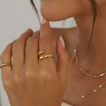 Soft Touch Ring in gold stainless steel, adjustable open ring with smooth rounded ends worn on hand.

