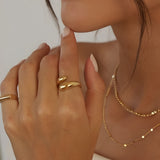 Soft Touch Ring in gold stainless steel, adjustable open ring with smooth rounded ends worn on hand.
