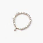 Minimal uniform pearl bracelet with gold accent by About Ease